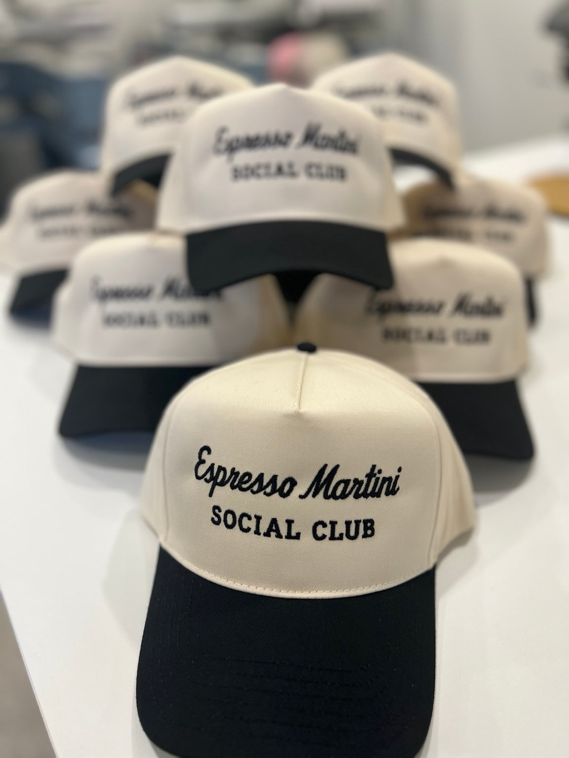Embroidered Espresso Martini Social Club hats in the Gunnar & Fox studio